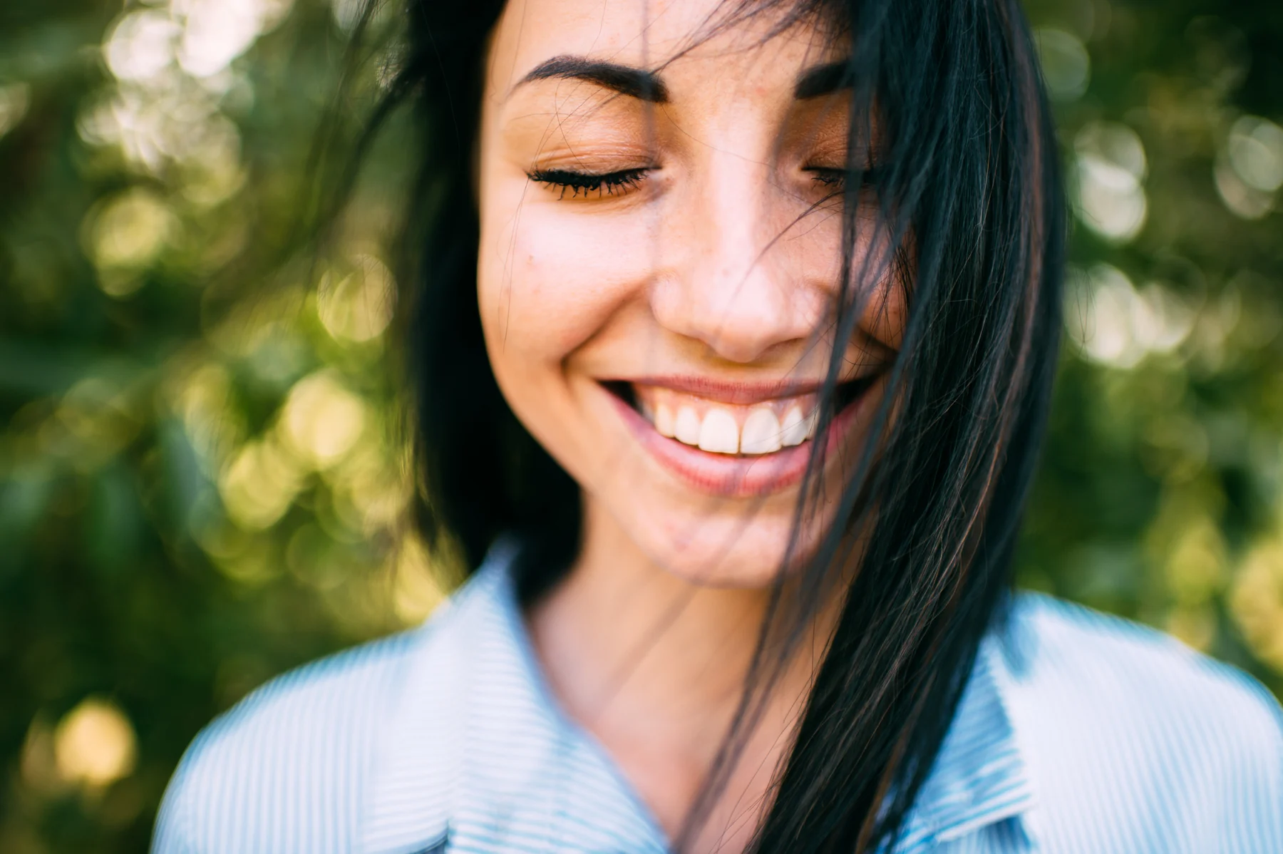 A woman smiling outdoors